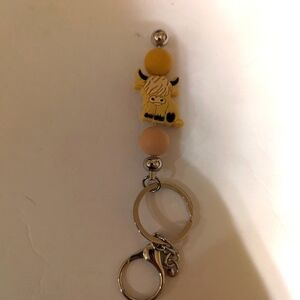 Highland cow stick keychain.